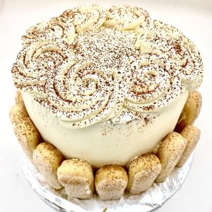 Four-layered tall elegant cake with three layers of filling