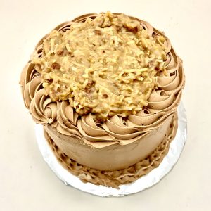 Four-layered tall elegant cake with three layers of filling