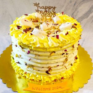 Cardamom sponge cake with saffron milk, rasmalai, nuts, and rose petals.