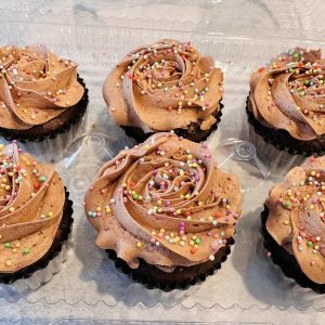 Set of 6 large cupcakes with colored liners.
