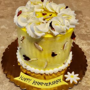 Cardamom sponge cake with saffron milk, rasmalai, nuts, and rose petals.
