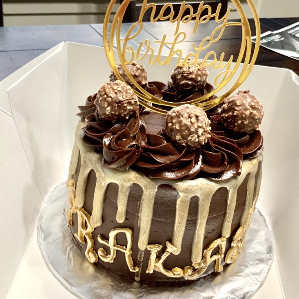Four-layered tall elegant cake with three layers of filling