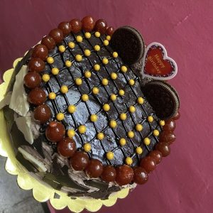 Signature Death By Chocolate Cake with layers of ganache and choco chips.