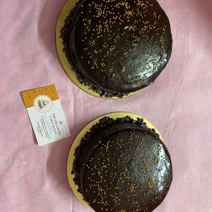 Signature Death By Chocolate Cake with layers of ganache and choco chips.