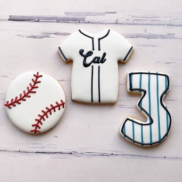 Custom decorated sugar cookies arranged on a plate.