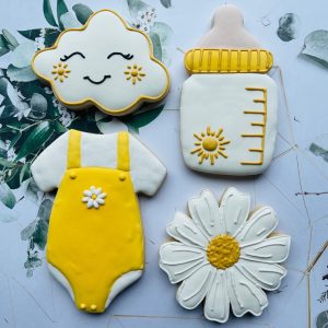 Custom decorated sugar cookies arranged on a plate.