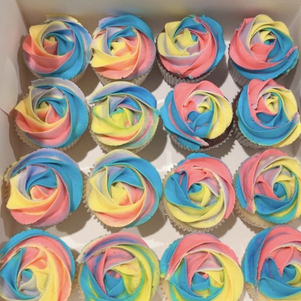 Delightful mini cupcakes with swirled frosting in various flavors.