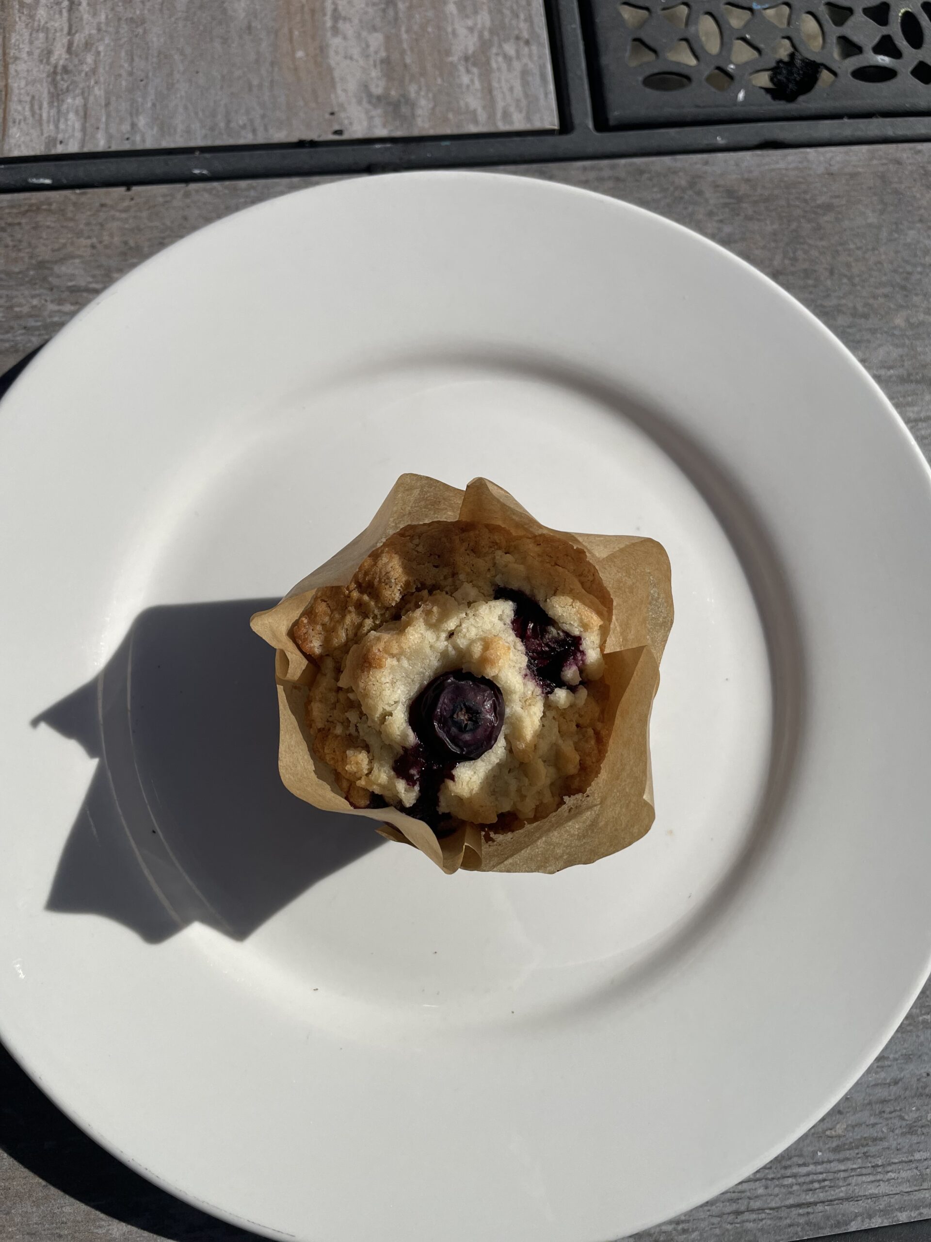 Freshly baked blueberry muffin with juicy blueberries.