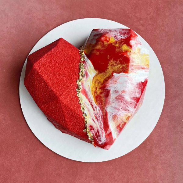 Heart-shaped custom mousse cake with mirror glaze and gold accents.