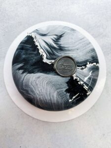 Elegant Marble Mousse Cake Elegant black-and-white marble mousse cake with silver accents