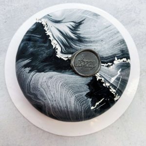 Elegant black-and-white marble mousse cake with silver accents