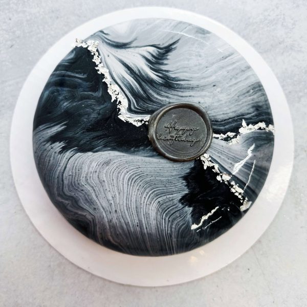Elegant black-and-white marble mousse cake with silver accents
