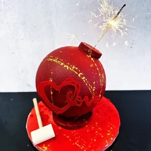 Mini Showstopper cake with candies, macarons, and confetti inside.