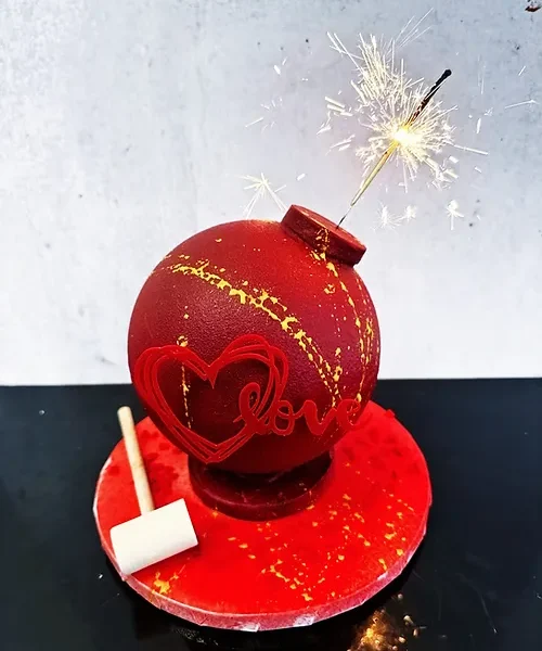 Mini Showstopper cake with candies, macarons, and confetti inside.