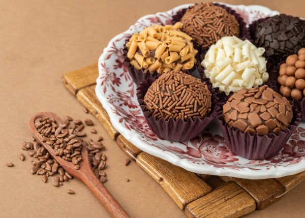 Typical brazilian brigadeiros on a plate with chocolate sprinkles.